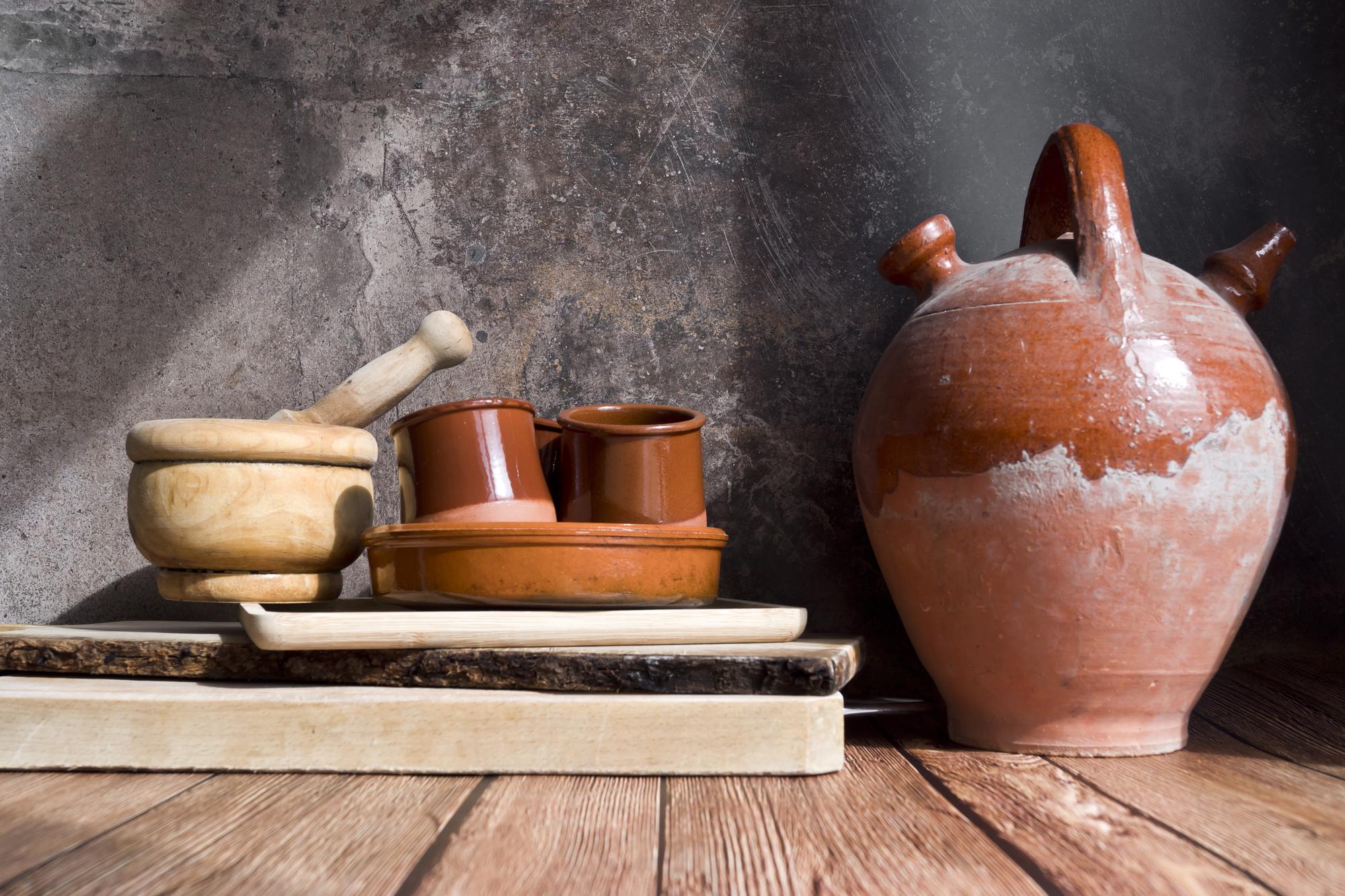 Small kitchen studio with copper pots and wooden table